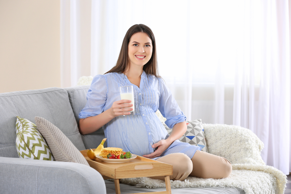 Mujer embarazada con comida saludable